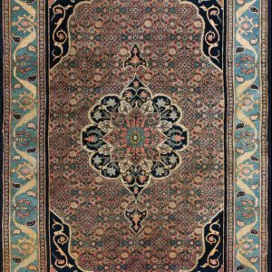 Intricate patterned rug with a coral field, navy medallion, and wide teal border with paisley details.