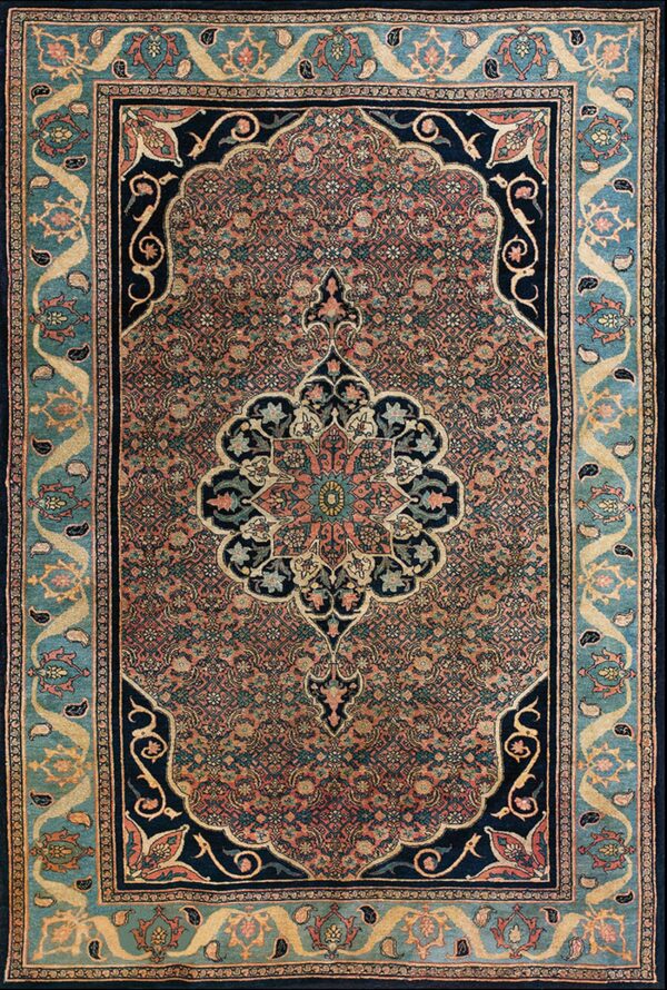 Intricate patterned rug with a coral field, navy medallion, and wide teal border with paisley details.