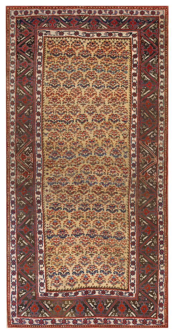 Low-pile rug with a beige field of repeating floral patterns and a wide dark brown geometric border.