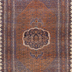 Rust and indigo traditional rug with a central medallion, ornate corner spandrels, and complex borders.