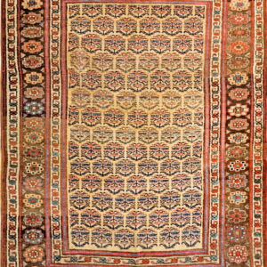 Light tan field rug with repeating blue and red floral motifs, surrounded by complex dark brown borders.