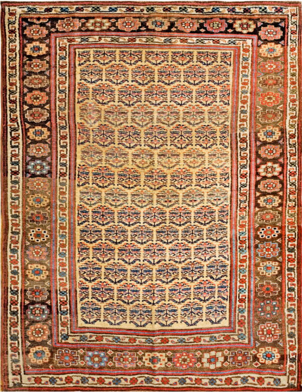 Light tan field rug with repeating blue and red floral motifs, surrounded by complex dark brown borders.