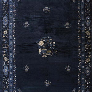 Plush navy area rug with symmetrical patterns of flowers and vases in light blue, gold, and cream.