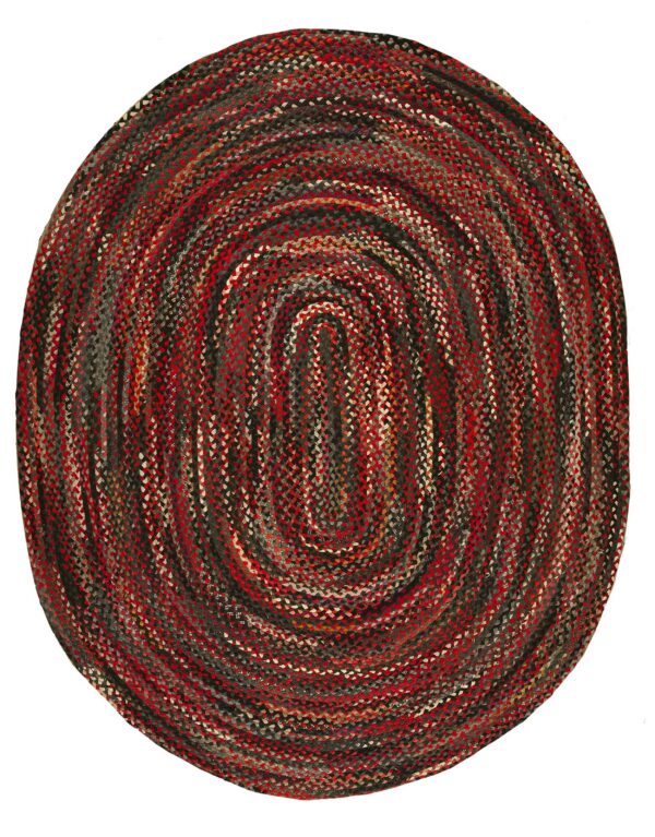 Circular braided rug with an oval coiled design featuring mixed tones of red, black, and gray woven strips.