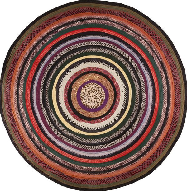 Round braided rug displaying concentric rings of multicolored solids and mixed tweed patterns.