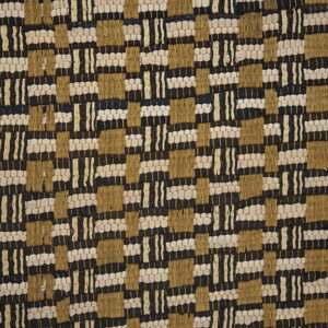 Low-profile textured rug with a black, beige, and tan geometric woven pattern on a wooden floor.