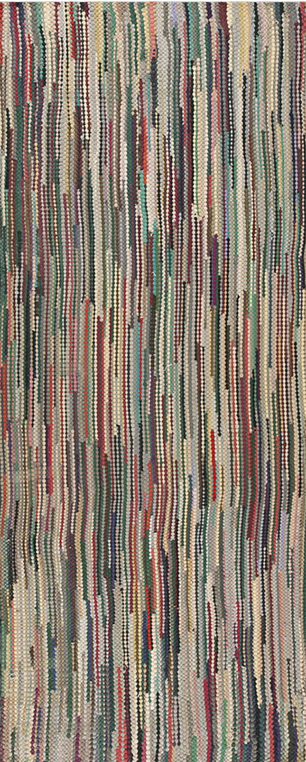 Multicolor rug with a textured, low pile surface made of thin vertical strips in green, red, and gray tones.