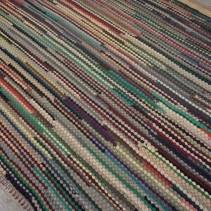 Textured, low-pile rug with variegated diagonal stripes of small braided loops in multiple earthy colors.