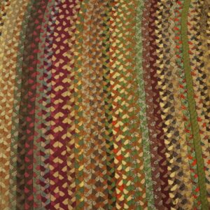 Braided area rug displaying vertical rows of multicolored browns, burgundy, and olive green on light wood flooring.