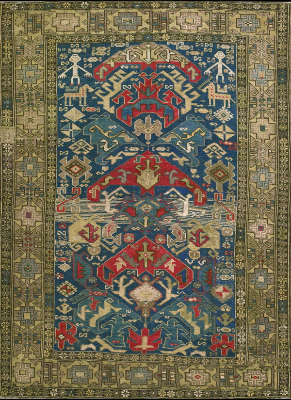 Detailed geometric rug in blue, red, beige, and olive green features stylized figures and animals.