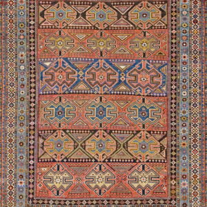 Multicolored rug with a highly detailed geometric pattern of rust, blue, and brown horizontal bands.