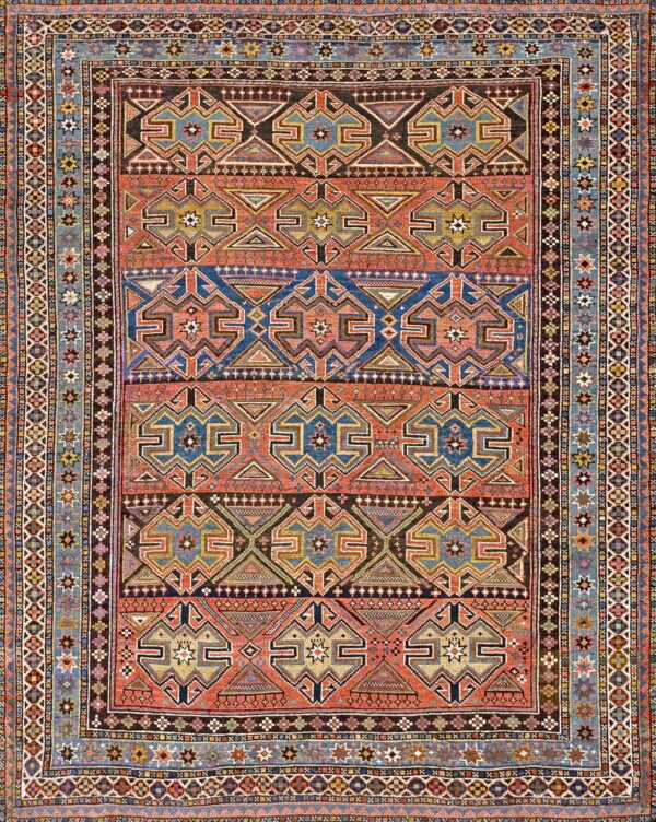Multicolored rug with a highly detailed geometric pattern of rust, blue, and brown horizontal bands.