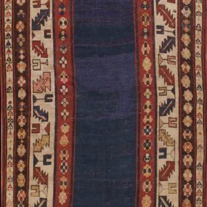 Low-pile rug with a solid navy blue field framed by multiple geometric borders in red, cream, and brown.