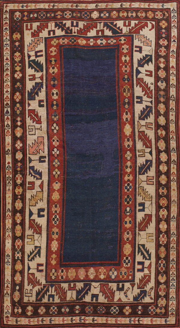 Low-pile rug with a solid navy blue field framed by multiple geometric borders in red, cream, and brown.