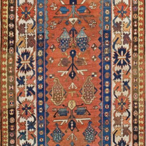 Geometric rug with stylized motifs on a burnt orange field, framed by complex blue and cream borders.