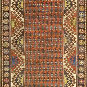 Rectangular rug featuring a terracotta field, repeating dark motifs, and wide multicolored geometric borders.