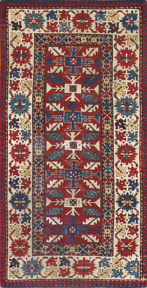 Geometric runner rug featuring a red center field framed by cream borders with stylized blue, red, and yellow motifs.