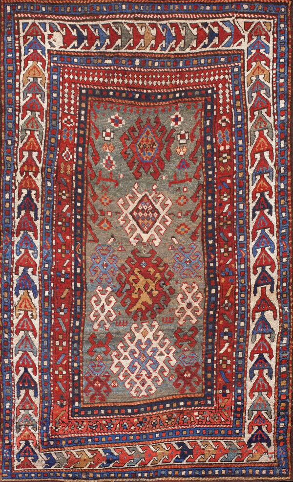 Geometric rug with a slate gray-blue center containing tribal motifs and complex multi-layered red borders.