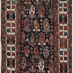 A long runner rug featuring a dark blue field filled with repeating rust and cream boteh motifs.