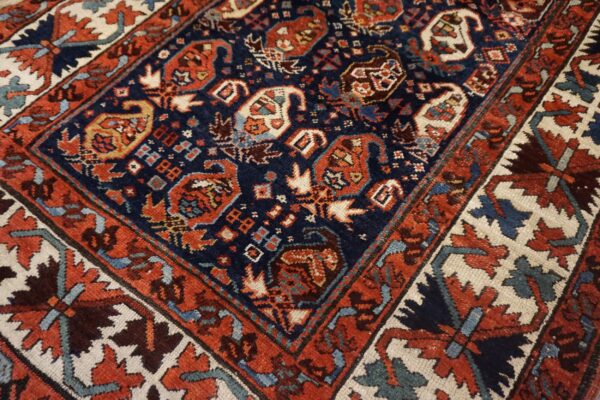 High-pile rug detail in navy, rust, and cream, featuring intricate geometric and stylized paisley designs.