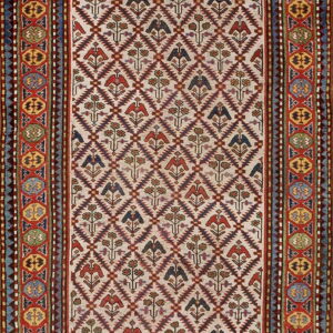 A cream and maroon rug with stylized bird and floral motifs inside a continuous geometric diamond pattern.