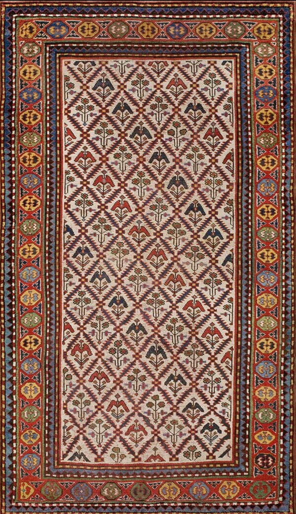 A cream and maroon rug with stylized bird and floral motifs inside a continuous geometric diamond pattern.