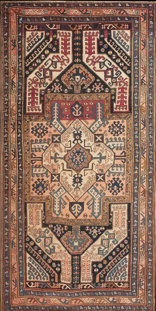 Intricate geometric rug featuring a central medallion in navy, cream, burgundy, and dusty rose tones.