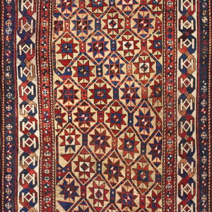 Low pile rug with a complex red, navy blue, and cream geometric pattern and detailed multi-band borders.