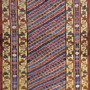 Flatwoven runner featuring diagonal stripes of blue, red, and orange, framed by geometric khaki borders.