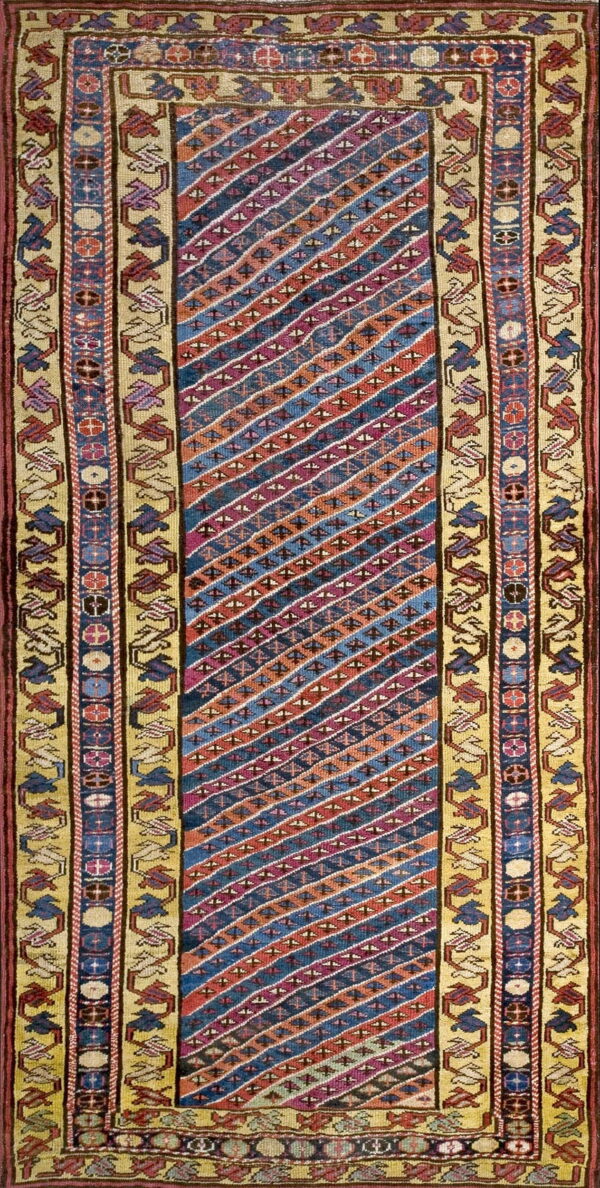 Flatwoven runner featuring diagonal stripes of blue, red, and orange, framed by geometric khaki borders.