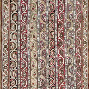 Vertical striped rug featuring repeating boteh motifs in red, black, sage, beige, and cream colors.