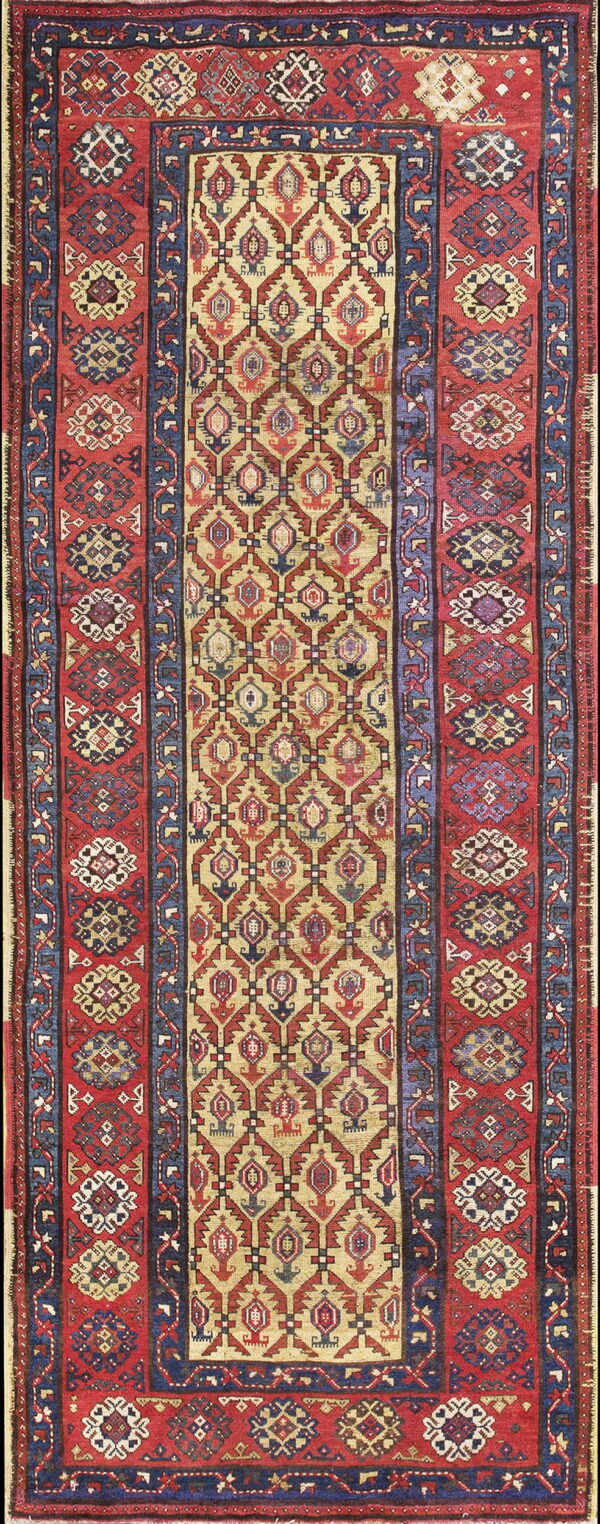 Geometric runner rug featuring a central tan field of repeating diamonds flanked by wide red and blue borders.