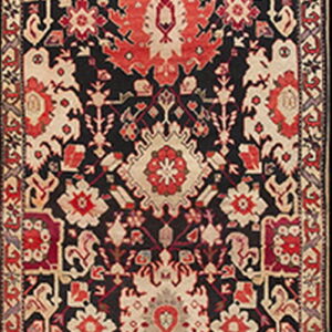 Narrow runner rug displays a complex geometric and stylized floral pattern in black, bright red, cream, and gray.