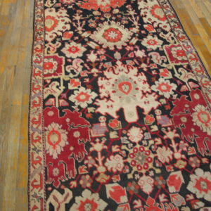 Runner rug featuring a red, cream, and dark floral medallion pattern on light wooden floor planks.