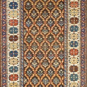 Brown and cream rug featuring a repeating diamond and stylized plant motif surrounded by colorful medallions.