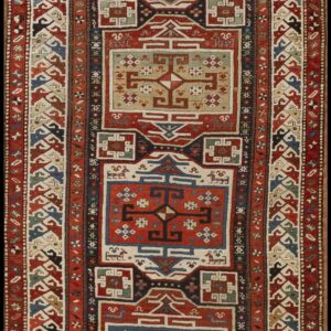 Long runner rug with repeating geometric medallions in red, navy blue, cream, and olive green, surrounded by complex tribal borders.
