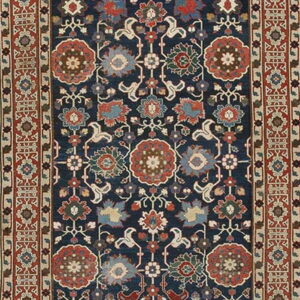Navy blue traditional runner rug featuring detailed rust, light blue, and green floral medallions and geometric borders.