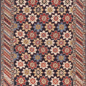 Navy rug featuring red, cream, and blue geometric motifs and a detailed striped, patterned border.