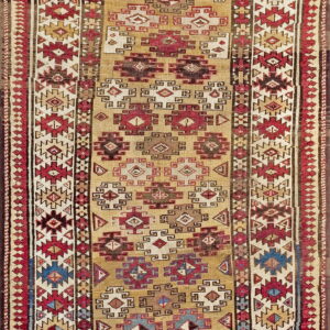 Flatweave runner with a gold field and intricate geometric patterns in red, brown, cream, and blue accents.
