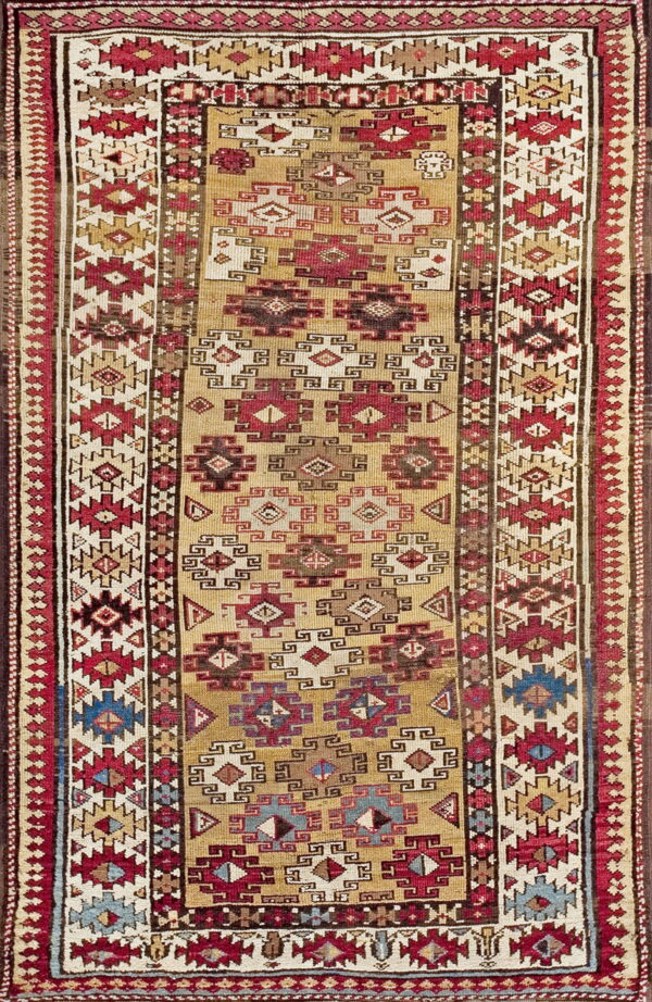 Flatweave runner with a gold field and intricate geometric patterns in red, brown, cream, and blue accents.