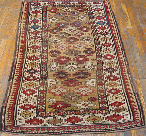 Narrow runner rug with a tan field and intense red, cream, blue, and brown geometric tribal patterns on wood floor.