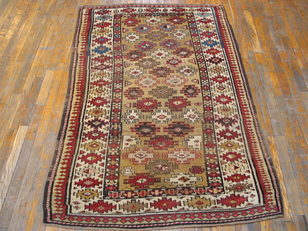 Geometric runner rug featuring complex red, tan, and dark brown motifs on wood planks.