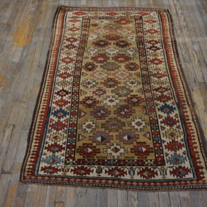 Geometric runner rug in gold, red, blue, and cream colors on distressed wood flooring.