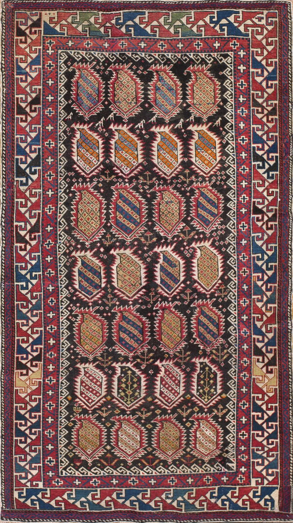 Dark field rug with red, blue, and gold geometric medallions and wide, complex red borders.