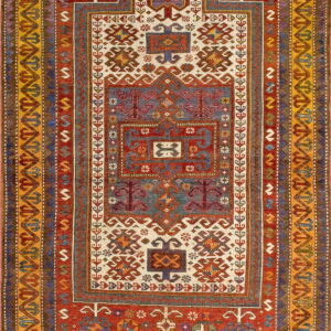 Geometric prayer rug design featuring dense tribal motifs on red, indigo, and cream fields.