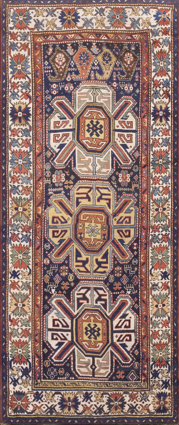 Vertical runner rug featuring a central navy field with three geometric medallions in yellow, terracotta, and cream accents.