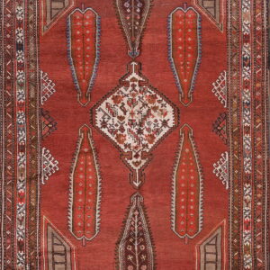 Red rug featuring serrated boteh motifs, a multi-band border, and a contrasting white geometric medallion.