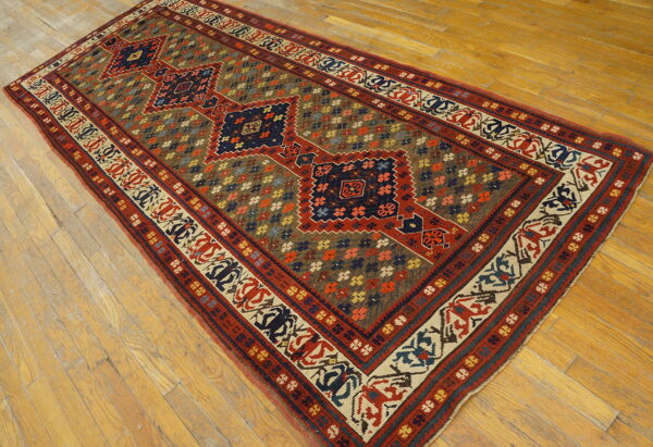 Traditional runner with repeating red and blue diamonds on a dense brown field over wood flooring.