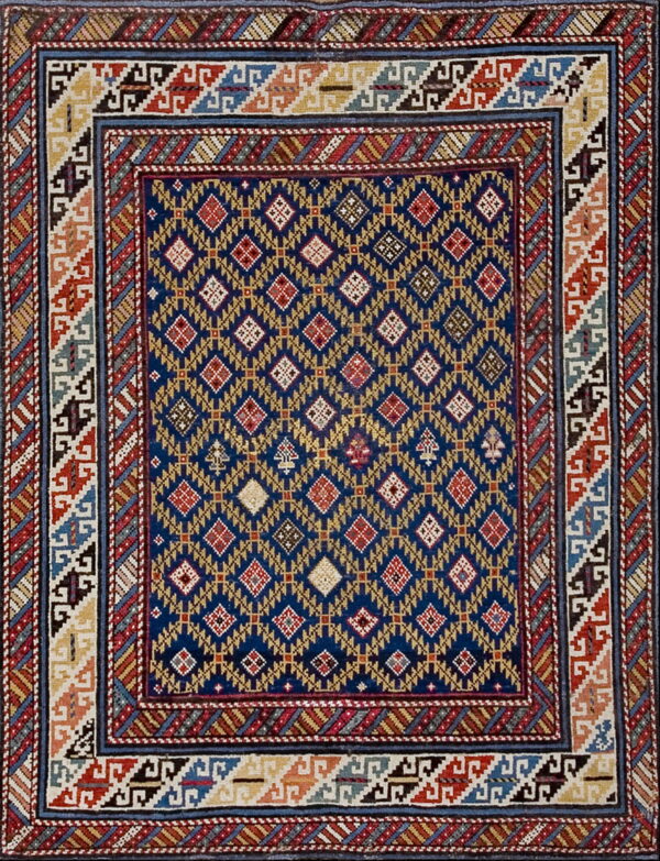 Geometric rug featuring a blue field with repeating yellow and red diamonds and complex multicolored borders.