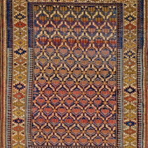 Geometric rug featuring a deep blue and rust repeating motif field with intricate gold and blue striped borders.